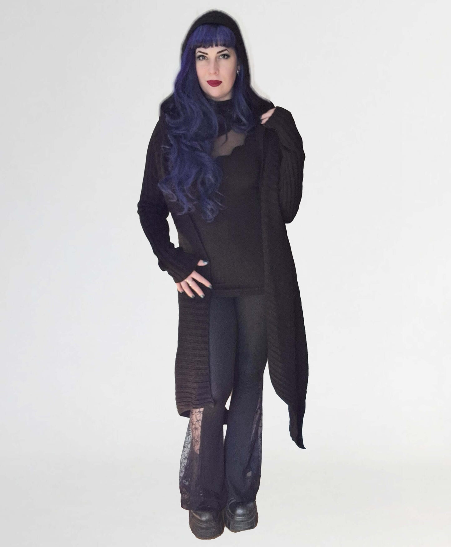 Necessary Evil Sabrina Ribbed Hooded Cardigan in black, elegantly draping over a model showcasing the luxurious ribbed texture and oversized hood, perfect for gothic layering.