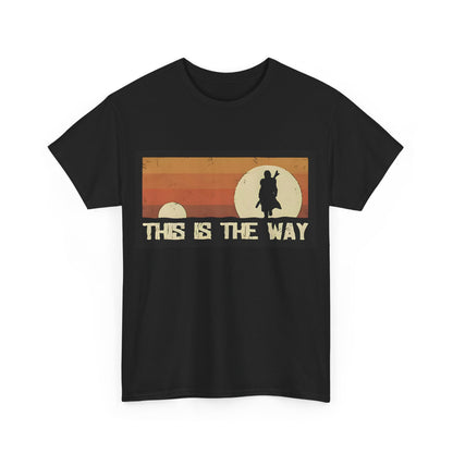 Luxury unisex tee shirt featuring Mandalorian-themed graphic design with the phrase 'THIS IS THE WAY', set against a vibrant sunset background in orange and beige, ideal for sophisticated fans of Star Wars.