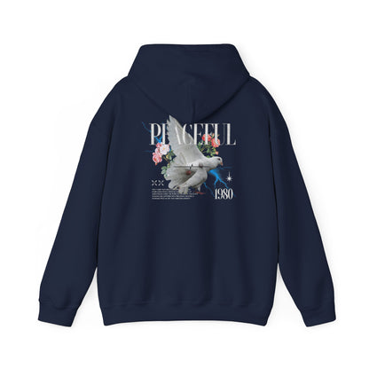 Chic navy hoodie displaying a graceful dove artwork on the back, adorned with delicate floral accents and the word 'PEACEFUL', complete with a retro touch of '1980', perfect for a sophisticated casual look.