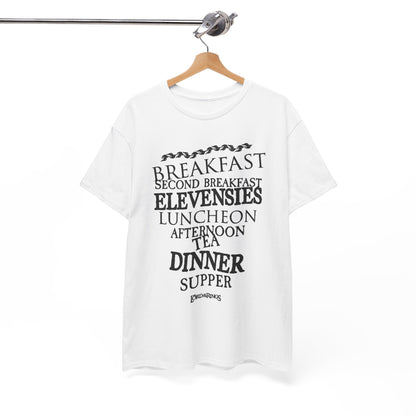 Chic white tee hanging neatly, adorned with playful designs of Hobbit meal times, merging comfort with a touch of elegance for everyday wear.
