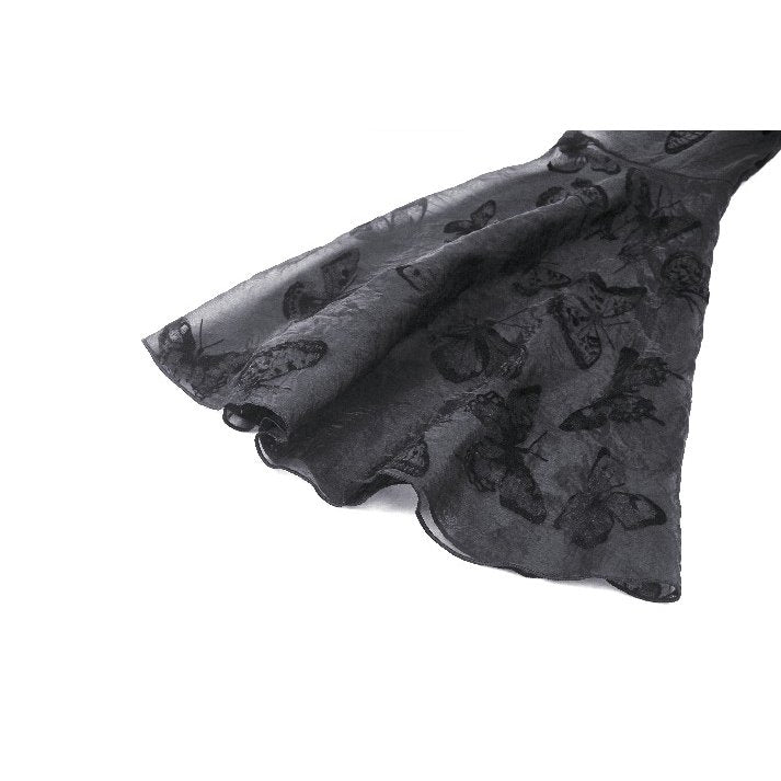 Model wearing the Dark in Love Blanche Victorian gothic dress with dramatic butterfly sleeves, exuding confidence and theatrical elegance.