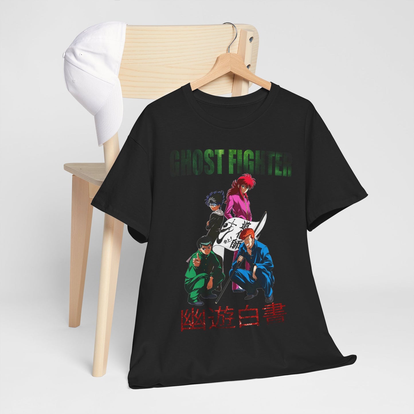 Stylish Ghost Fighter T-shirt draped over a minimalist wooden chair, paired with a cap, illustrating a chic casual outfit inspired by anime culture.