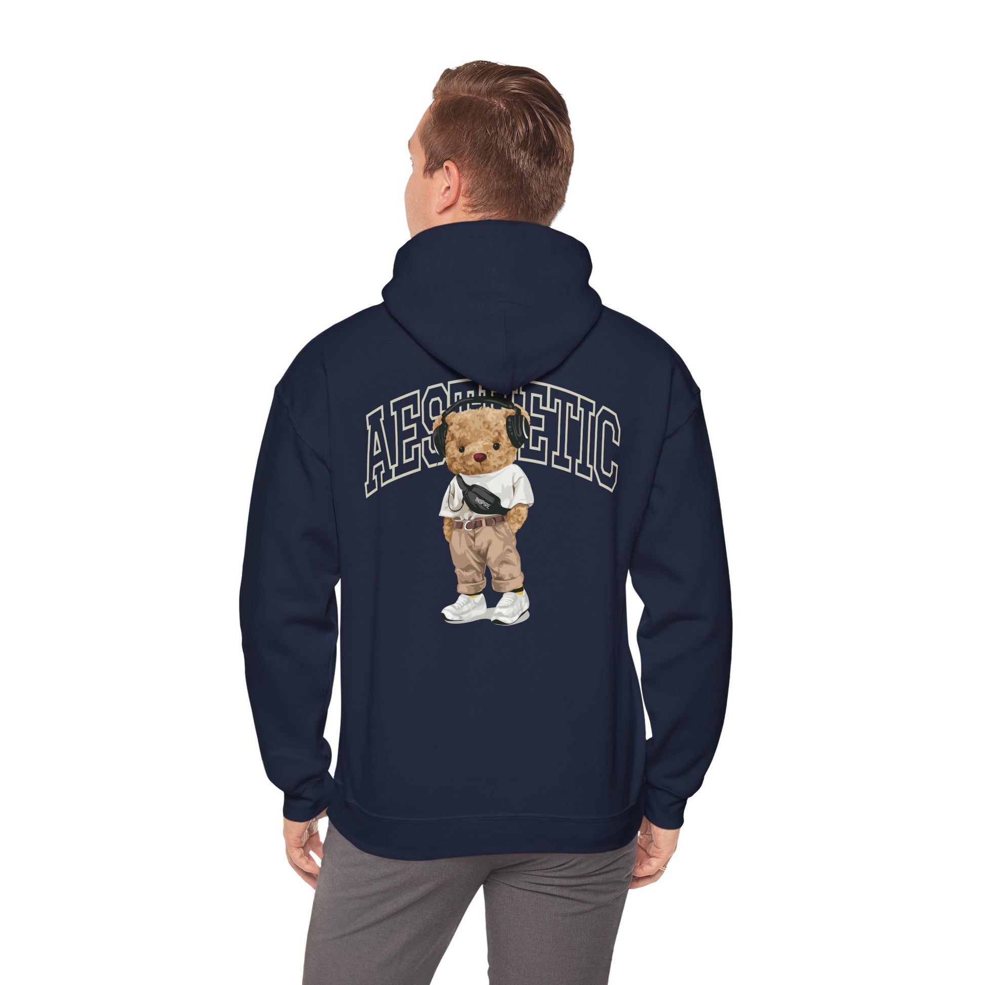 Chic navy hoodie worn by a model, featuring a captivating cartoon teddy bear design on the back, complemented by the word 'AESTHETIC,' merging comfort with modern style.