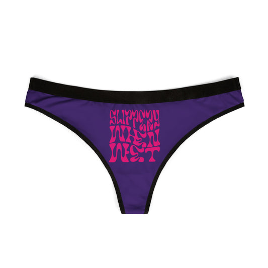 Elegant purple thong lingerie featuring the eye-catching 'SLIPPERY WHEN WET' design in vibrant pink, showcasing premium craftsmanship and contemporary flair.