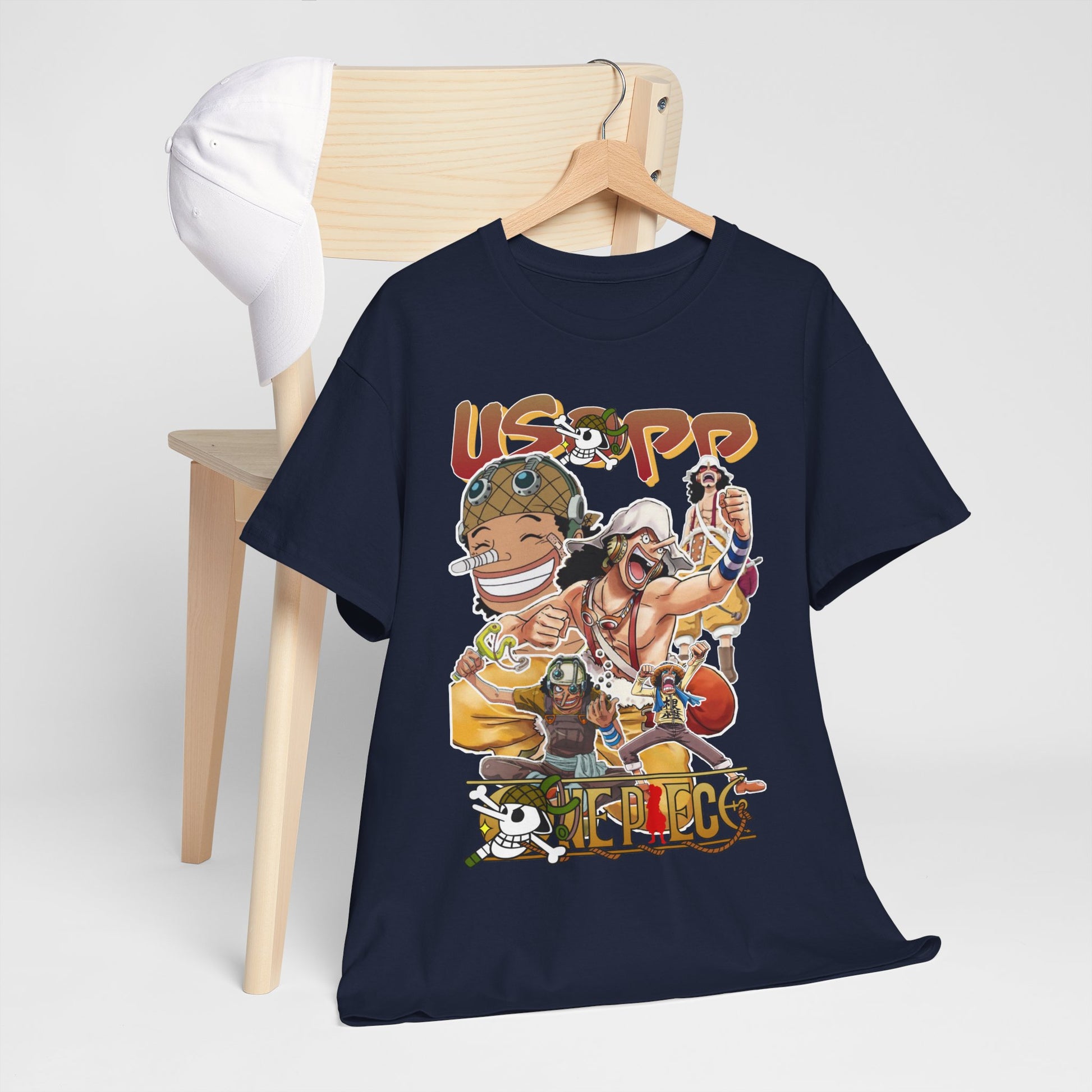 Tastefully arranged navy blue t-shirt with an enchanting design of Usopp alongside other anime characters, complemented by a chic cap, ideal for an upscale casual look.