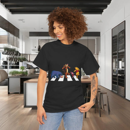 Luxury Pooh and Friends Abbey Road Graphic T-Shirt displayed by a model in a stylish kitchen, featuring whimsical characters from Winnie the Pooh on a black cotton fabric, perfect for urban streetwear enthusiasts.