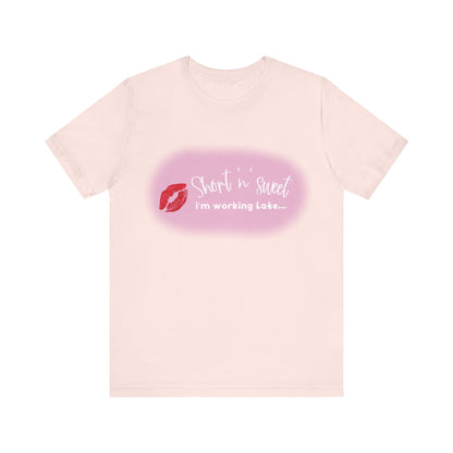 Sabrina Carpenter Inspired Unisex Short Sleeve Tee in a delicate pale pink tone adorned with a vibrant lipstick print, perfect for fashion-forward individuals.