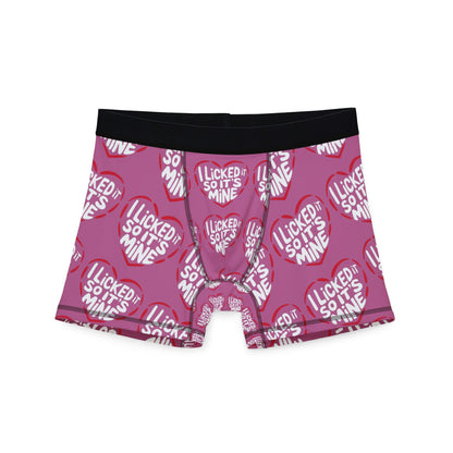 Valentine's Naughty Cheeky Men's Boxer Briefs showcasing the humorous slogan 'I LICKED IT SO IT'S MINE' in vibrant red hearts on a pink background, perfect for romantic occasions.