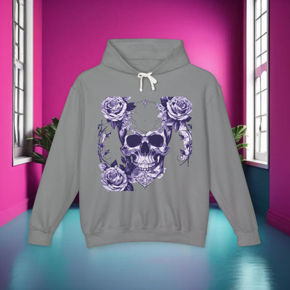 Luxury Unisex Lightweight Hooded Sweatshirt adorned with a designer skull and roses print, displayed in a softly lit room with a vivid pink accent wall.