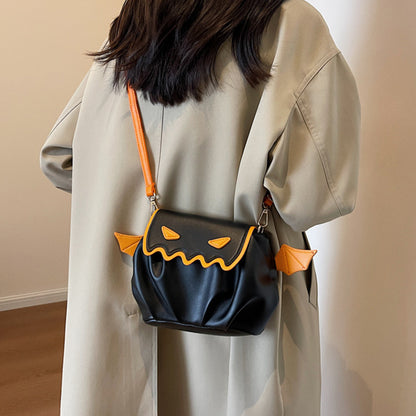 Elegant Funny Crossbody Bag - Halloween Pumpkin Cartoon Design, showcasing whimsical wings and a chic silhouette worn casually.