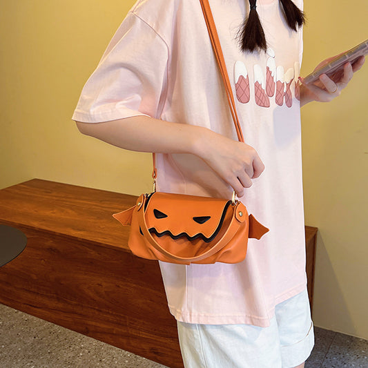 Versatile PU Crossbody Bags for Women - Trendy Orange & Black Halloween Style, showcased on a model wearing a pink T-shirt, holding a smartphone.