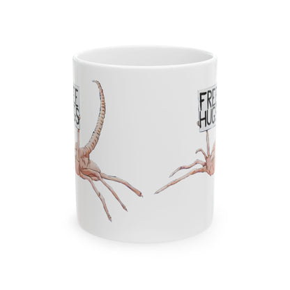 Funny Alien Xenomorph Facehugger ceramic mug with 'Free Hugs!' design - perfect for office laughs and caffeine fix.