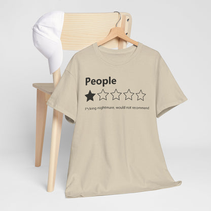 Elegant beige t-shirt displayed on a wooden chair alongside a stylish white cap, showcasing a striking 'People' print with a playful star rating. A chic addition to any wardrobe.