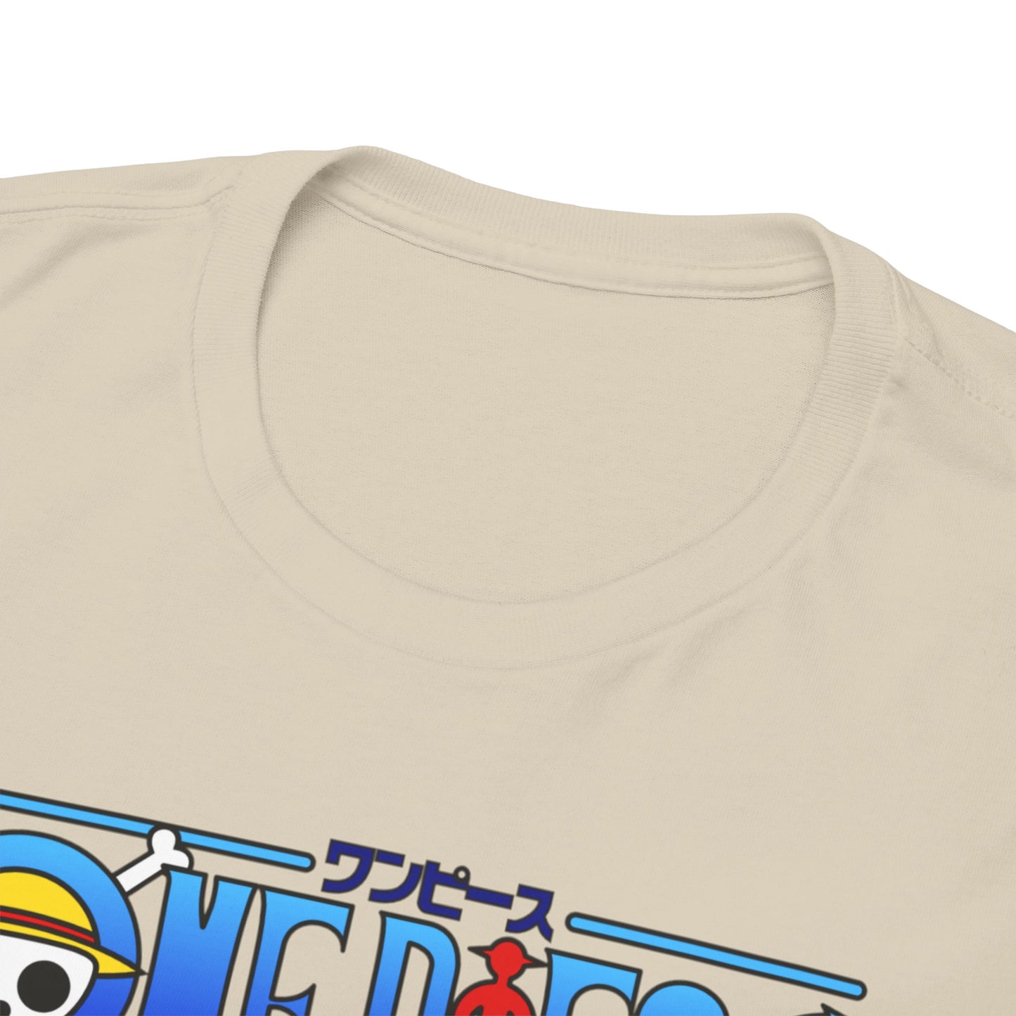 Close-up view of the neckline of a luxurious beige t-shirt featuring a vibrant One Piece graphic, showcasing intricate details and high-quality fabric.