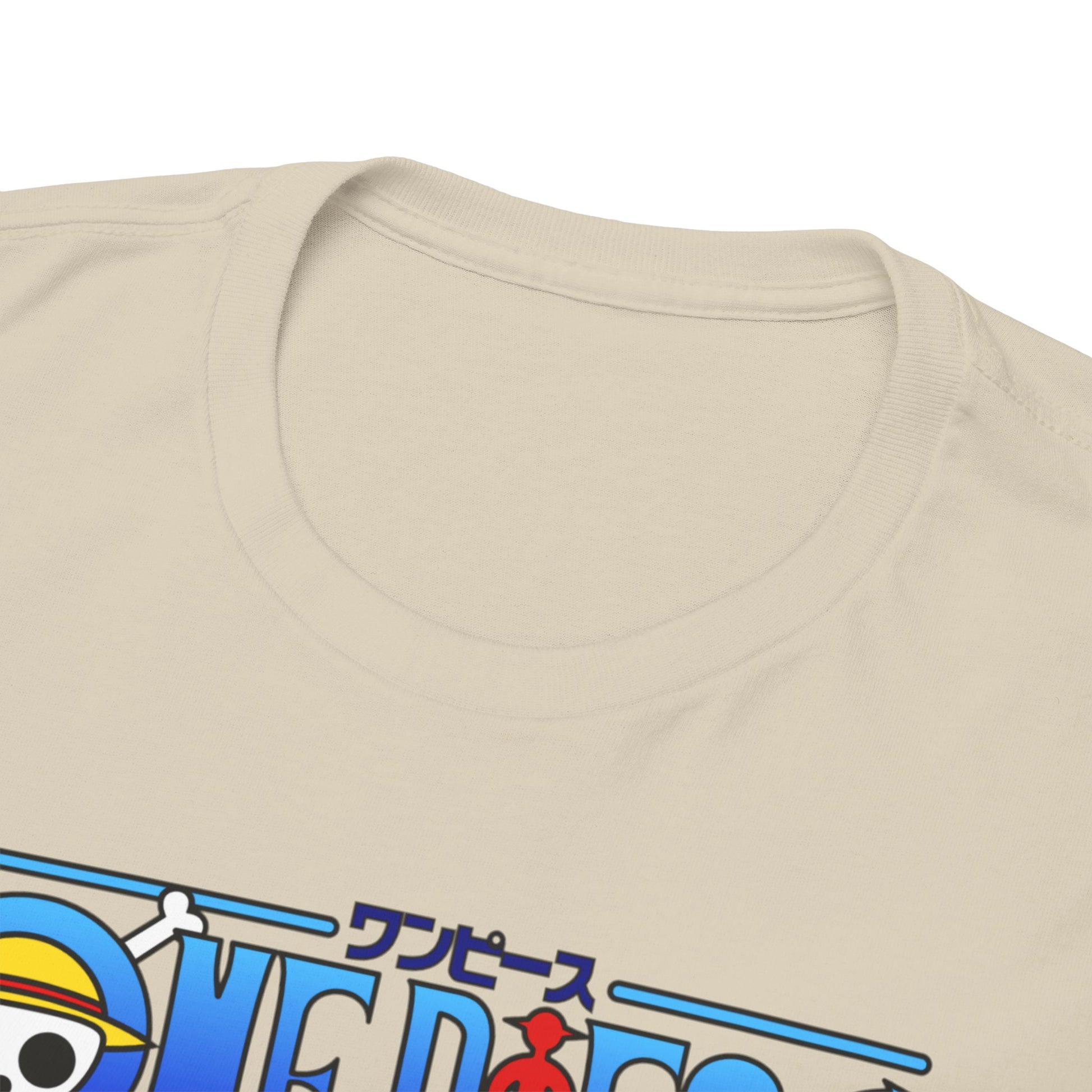 Close-up view of the neckline of a luxurious beige t-shirt featuring a vibrant One Piece graphic, showcasing intricate details and high-quality fabric.
