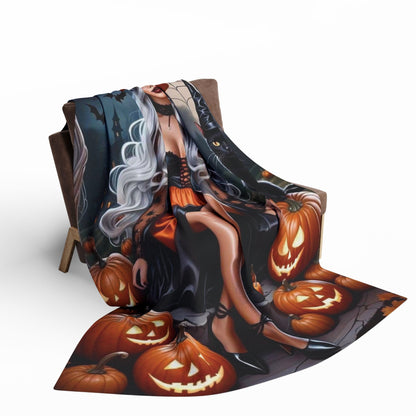 Elegant Decorative and Warm Halloween Spooky Arctic Fleece Blanket draped over a chair, featuring an enchanting Halloween scene with pumpkins and a stylish figure, perfect for adding a touch of luxury to your Halloween decor. Available in 3 sizes.