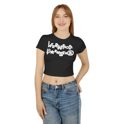 Fashionable woman in a black cropped baby T-shirt featuring striking white graphics reading 'INTERNATIONAL PARNSTAR®', a blend of elegance and playful charm.