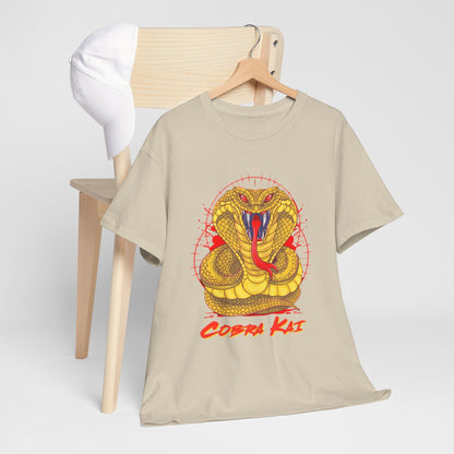 Stylish Cobra Kai graphic T-shirt positioned beside a white cap on a wooden hanger, presenting a trendy casual outfit for martial arts aficionados.