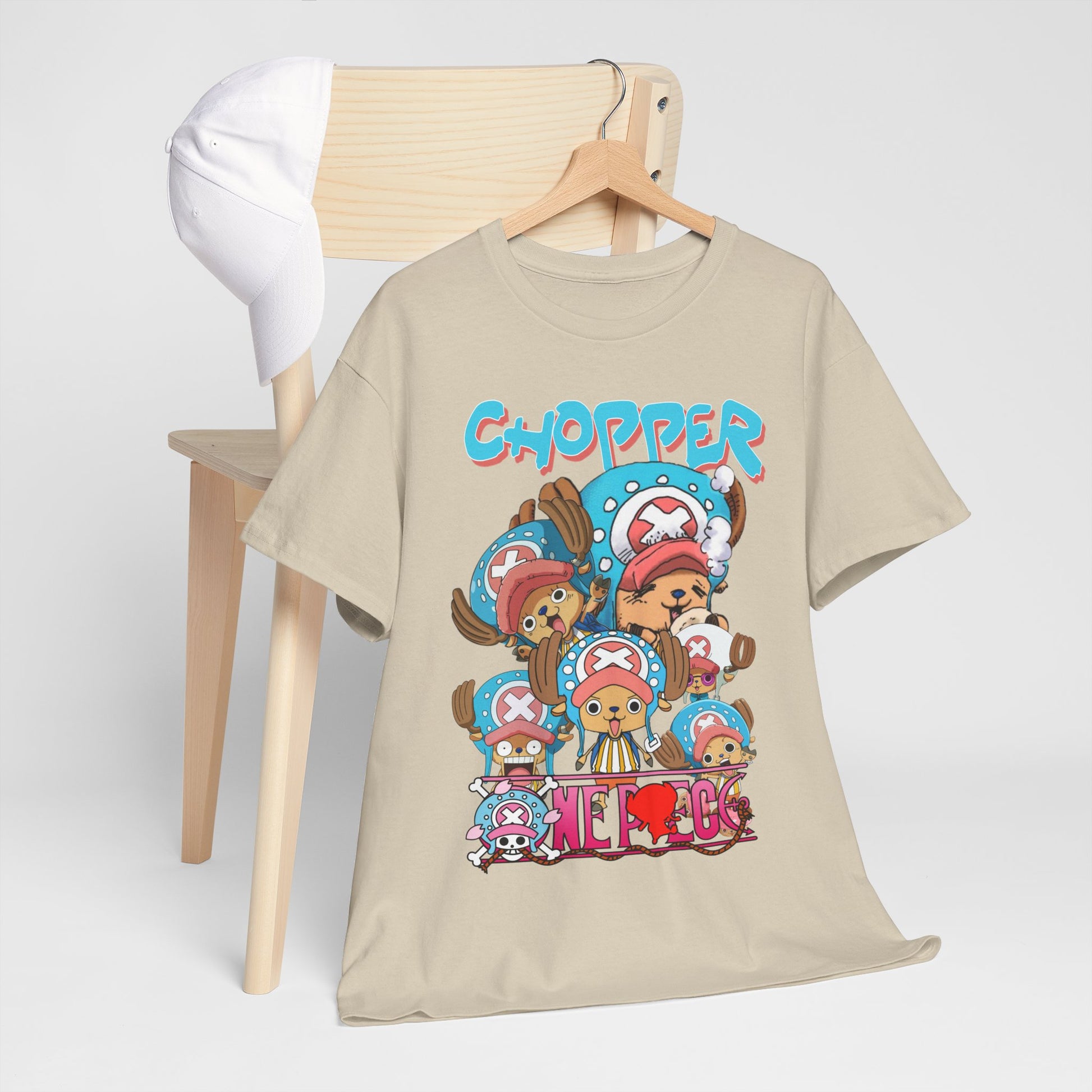 Luxurious anime graphic t-shirt featuring Chopper in playful poses, styled on a wooden hanger with a white cap, perfect for anime enthusiasts.