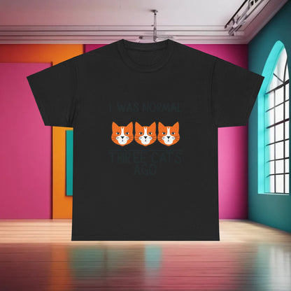 Luxurious black Crazy Cat Lady Graphic T-Shirt featuring an artistic design of three cat faces with the phrase 'I Was Normal Three Cats Ago'. Perfect for cat lovers seeking style and comfort.