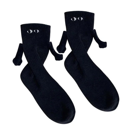 Elegant presentation of black Novelty Romantic Magnetic Holding Hands Couple Socks, featuring a charming eye motif and holding hands design for couples.