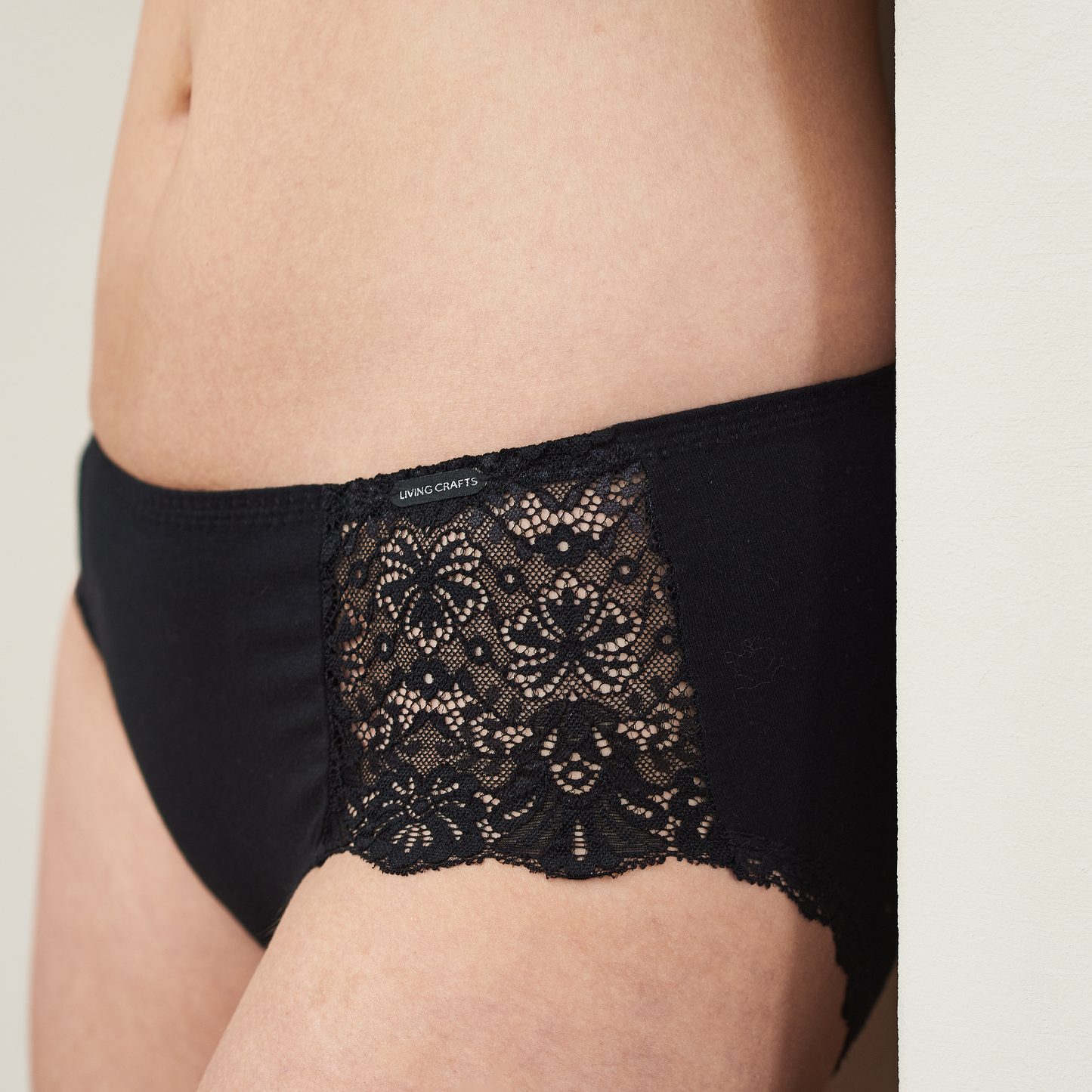 Front view of luxury organic lace trim briefs with Jacron label, showcasing versatility and style.