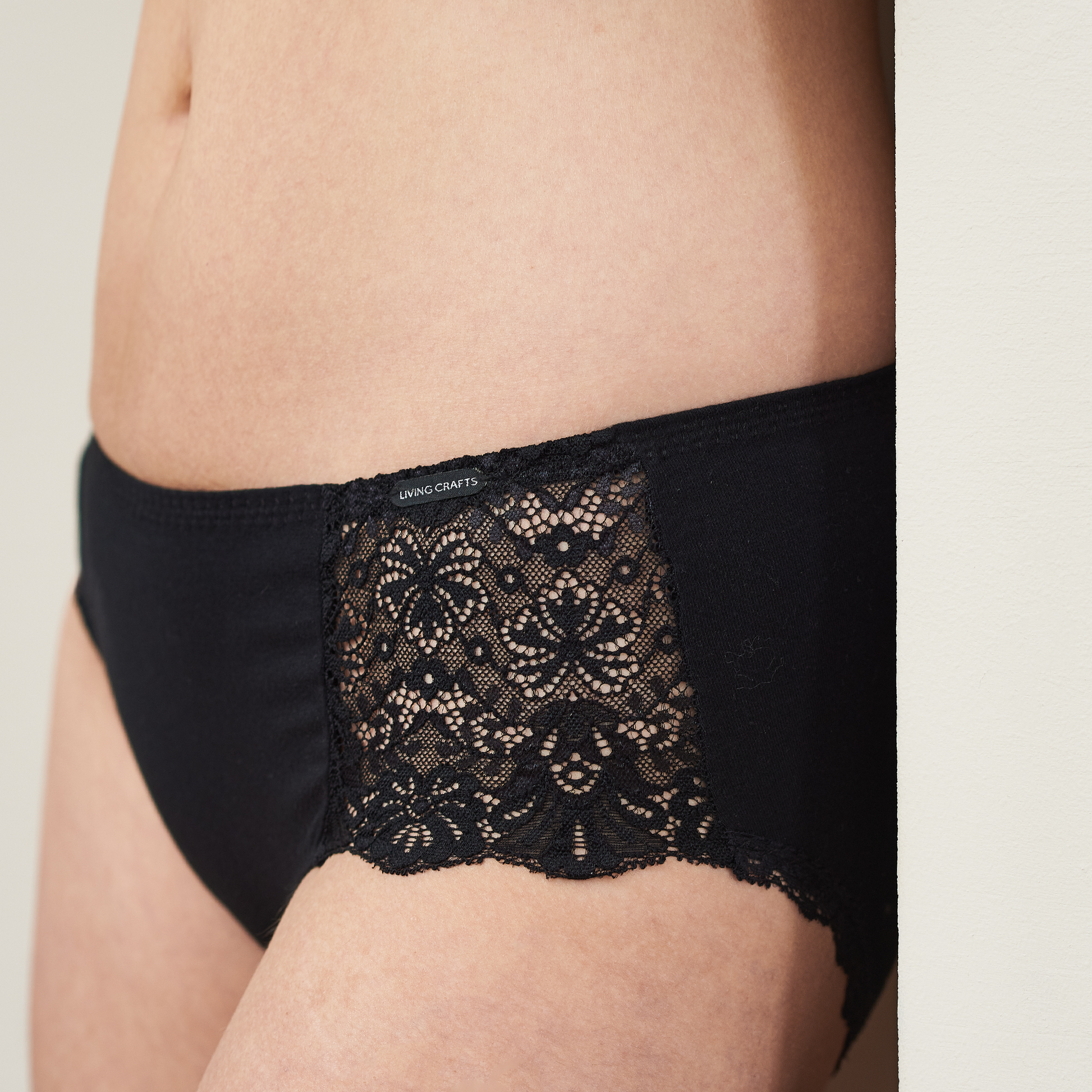 Front view of luxury organic lace trim briefs with Jacron label, showcasing versatility and style.