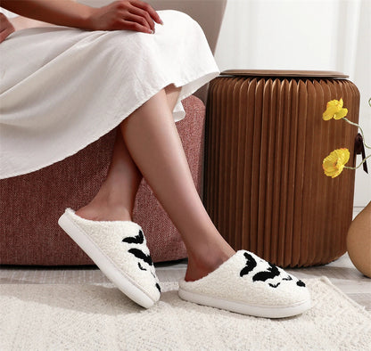 Side view of a person wearing Funny Bat Slipper Halloween Pumpkin Flat Indoor House Shoes, elegantly styled for casual comfort while lounging during the festive season.