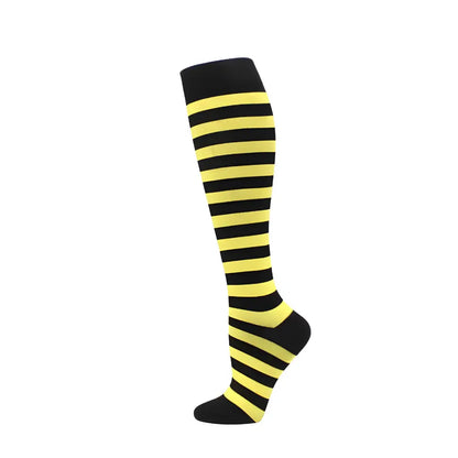 Elegant women's knee length compression travel socks with bold black and yellow stripes, offering a modern accessory for stylish travel experiences.