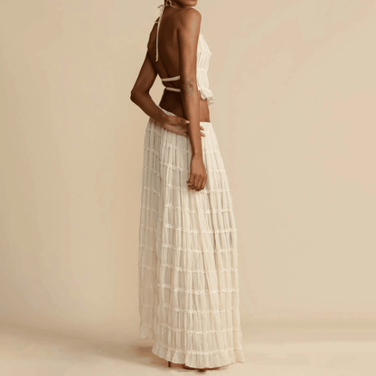 Elegant women's 2-piece sleeveless backless halter top paired with a pleated long skirt, perfect for summer occasions, showcasing luxury fashion style.