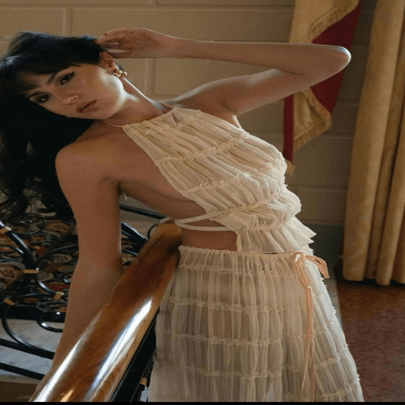 Stylish woman wearing the elegant women's sleeveless backless halter top and pleated long skirt, exuding sophistication for a casual beach outing.