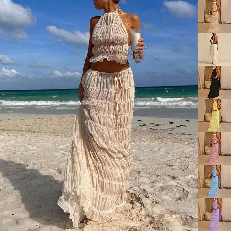 Elegant women's 2-piece sleeveless backless halter top paired with a pleated long skirt, showcasing a chic and luxurious summer outfit perfect for casual outings and special occasions.