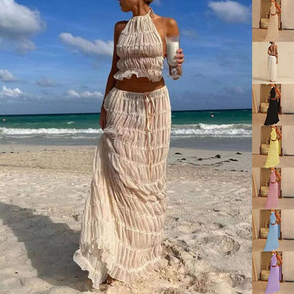 Elegant women's 2-piece sleeveless backless halter top paired with a pleated long skirt, showcasing a chic and luxurious summer outfit perfect for casual outings and special occasions.