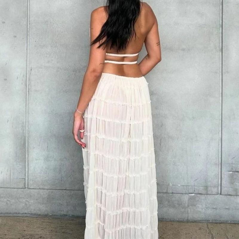 Stylish women’s 2-piece outfit featuring a cropped halter top and flowing pleated maxi skirt, ideal for casual events and holidays.