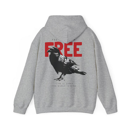 Chic grey hoodie adorned with a dramatic raven graphic and bold red 'YOU WERE BORN FREE' slogan. This stylish piece combines art and comfort, making it a perfect choice for an upscale casual outfit.