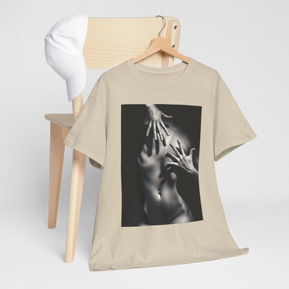 Elegant beige graphic t-shirt embellished with a striking artistic print of hands on a body, displayed on a minimalist wooden chair with a white cap.