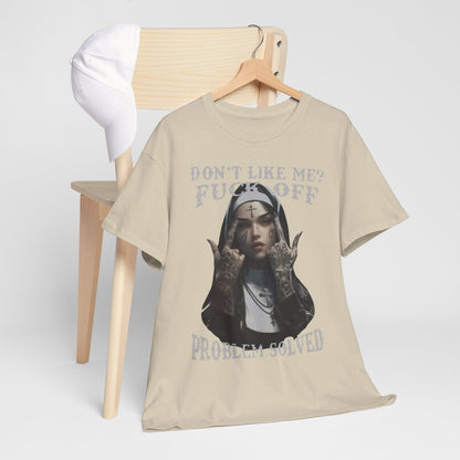 Chic t-shirt draped on a chair alongside a cap, featuring an eye-catching tattooed nun design with the phrase 'DON'T LIKE ME? FUCK OFF. PROBLEM SOLVED', an embodiment of style and attitude.