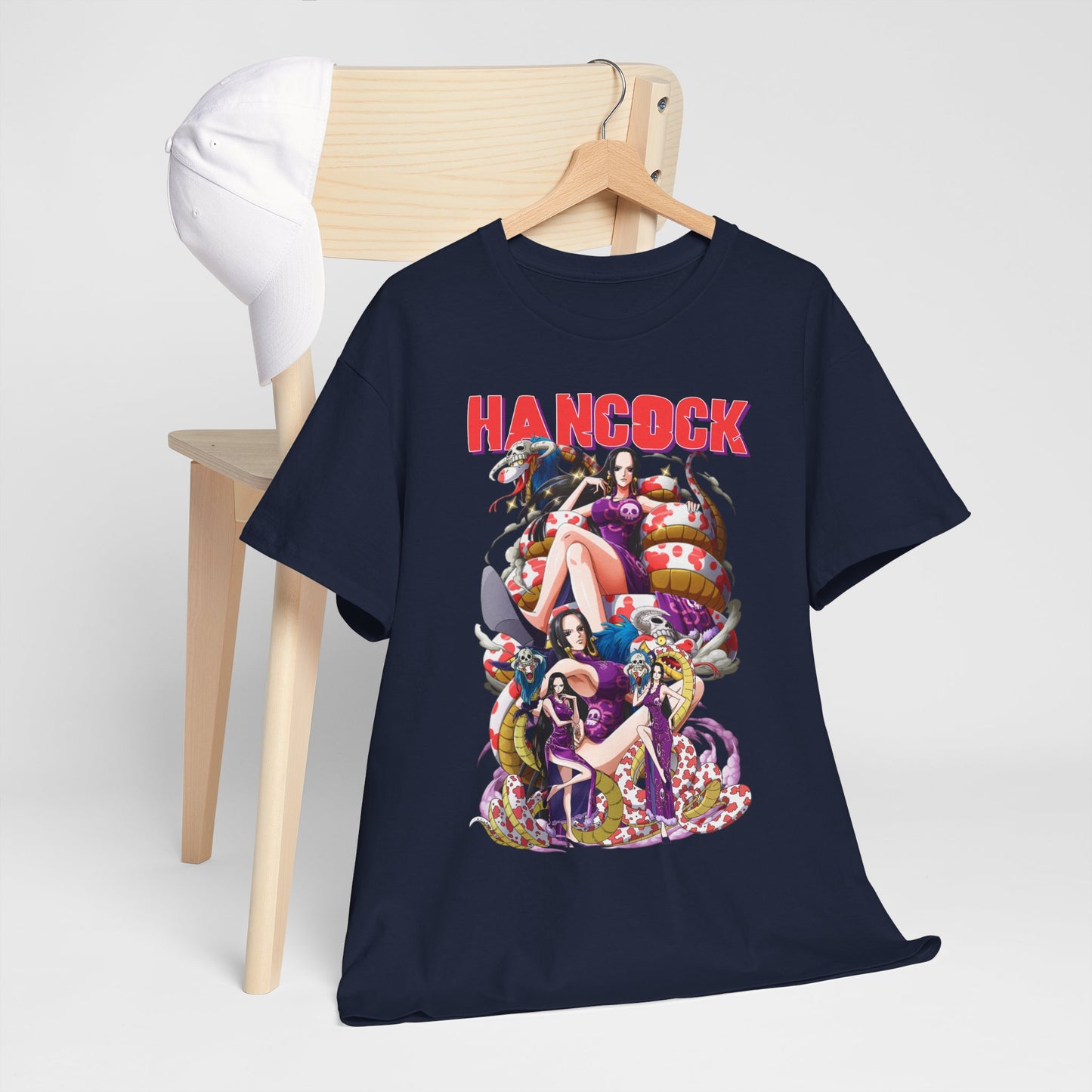 Stylish Hancock anime t-shirt displayed on a wooden chair with a white cap, featuring vibrant illustrations and bold design perfect for anime enthusiasts.