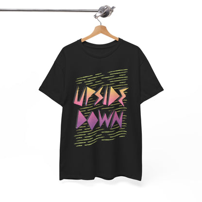 Sophisticated display of a black T-shirt with a bold 'UPSIDE DOWN' graphic, elegantly hanging on a wooden hanger, ideal for fashion-forward enthusiasts.