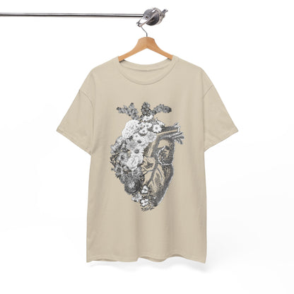 Hanging floral heart graphic t-shirt displayed on a wooden hanger, illustrating a sophisticated blend of anatomy and nature in muted tones.