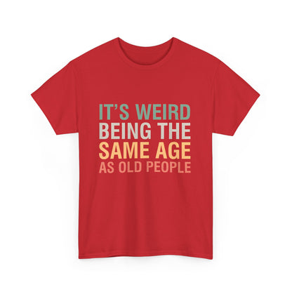 Luxurious red cotton graphic T-Shirt featuring the playful slogan 'It’s Weird Being The Same Age As Old People,' designed for unisex appeal and comfort.