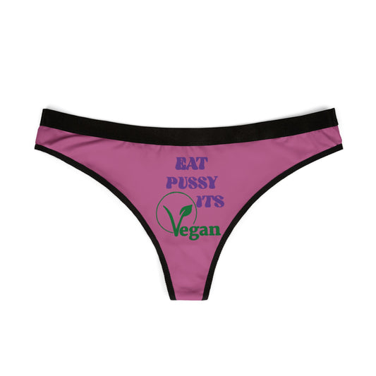 Elegant vegan thong panties showcasing the cheeky phrase 'Eat Pussy, It's Vegan' printed in eye-catching colours on a chic purple background, designed for the bold and playful woman.