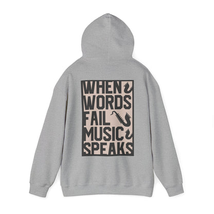 Stylish grey hoodie featuring the quote 'WHEN WORDS FAIL MUSIC SPEAKS' along with saxophone motifs, a perfect blend of elegance and musical passion.