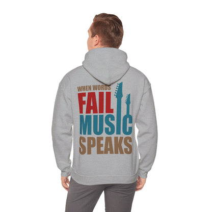 Model wearing a light grey hoodie with the powerful phrase 'When Words Fail Music Speaks' elegantly printed on the back, embodying style and passion for music.
