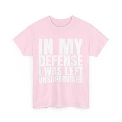 Stylish pink unisex graphic tee shirt displaying the witty phrase 'In My Defense, I Was Left Unsupervised', perfect for geek enthusiasts and crafted from soft cotton.