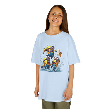 A girl smiling while wearing a light blue Minions T-Shirt Kids Despicable Me Banana Yellow Graphic Tee, showing off the fun design of three Minions splashing in the water, perfect for fun-loving kids. T Shirt, Funny, Minions.