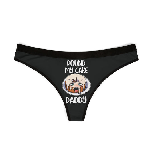 Luxurious black women's thong featuring a humorous graphic of a frosted cake with the playful phrase 'POUND MY CAKE DADDY' inscribed above, ideal for adding a cheeky touch to intimate celebrations.