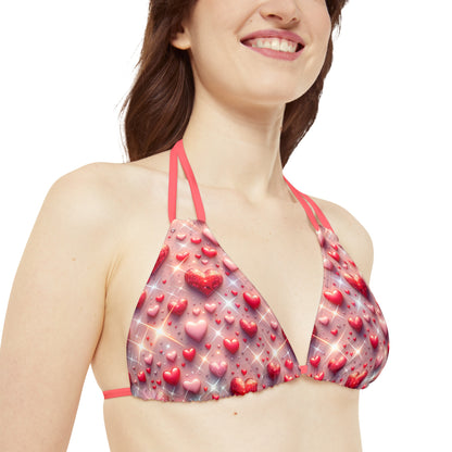 Close-up of the Pastel Pink Glittering Hearts Strappy Triangle Bikini Top from Dazzling Dreams Studio, highlighting the exquisite glitter detailing and adjustable strappy design for a flattering fit.