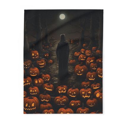 Luxurious Decorative and Warm Halloween Spooky Arctic Fleece Blanket featuring a haunting scene of a cloaked figure amidst a field of carved pumpkins under a full moon.