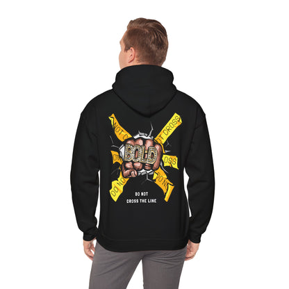 Stylish black hoodie worn by a model, displaying a bold artistic design on the back with a powerful fist and yellow warning banners, perfect for making a statement.